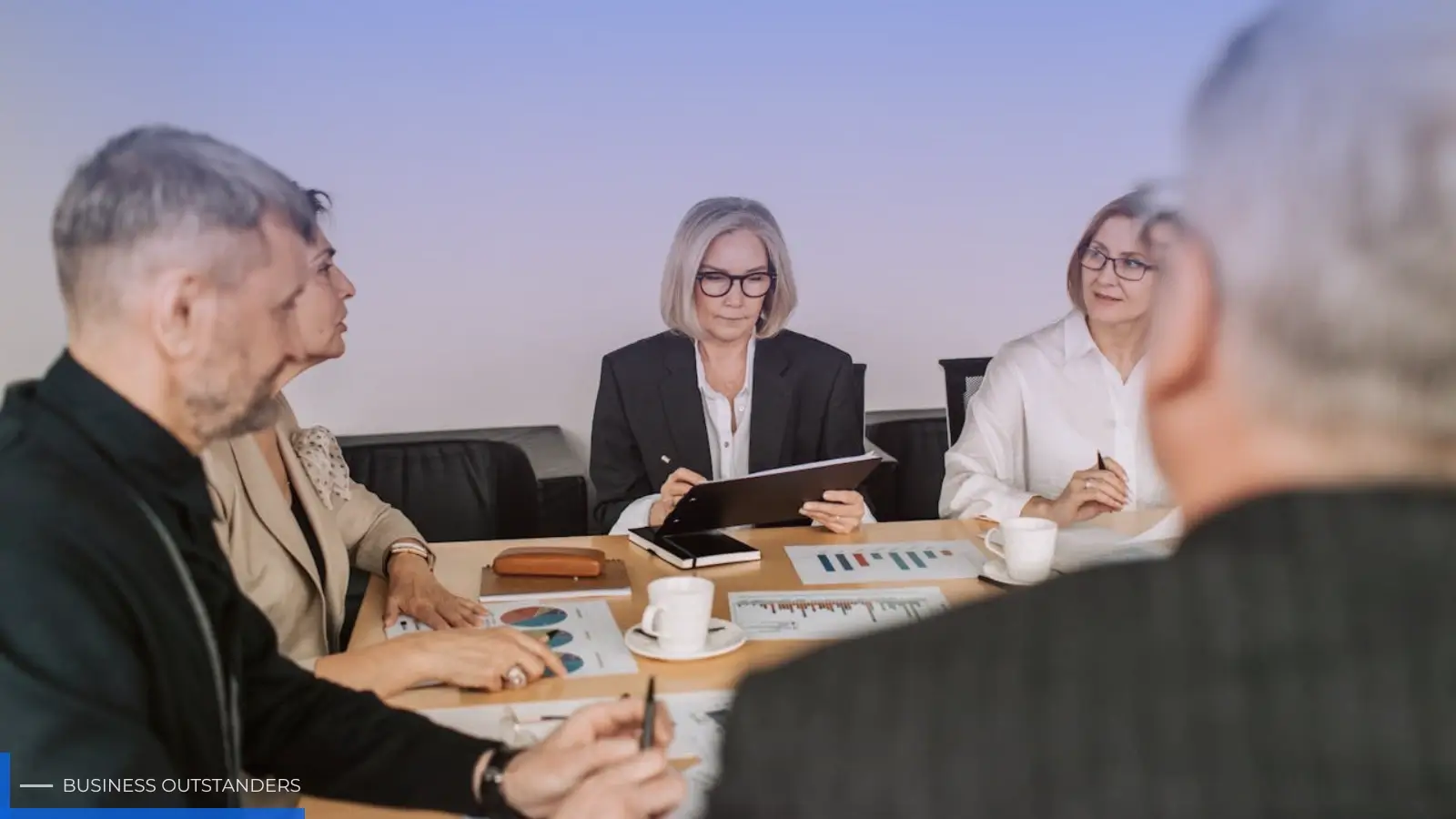 Business leader guiding a diverse team in a collaborative office environment