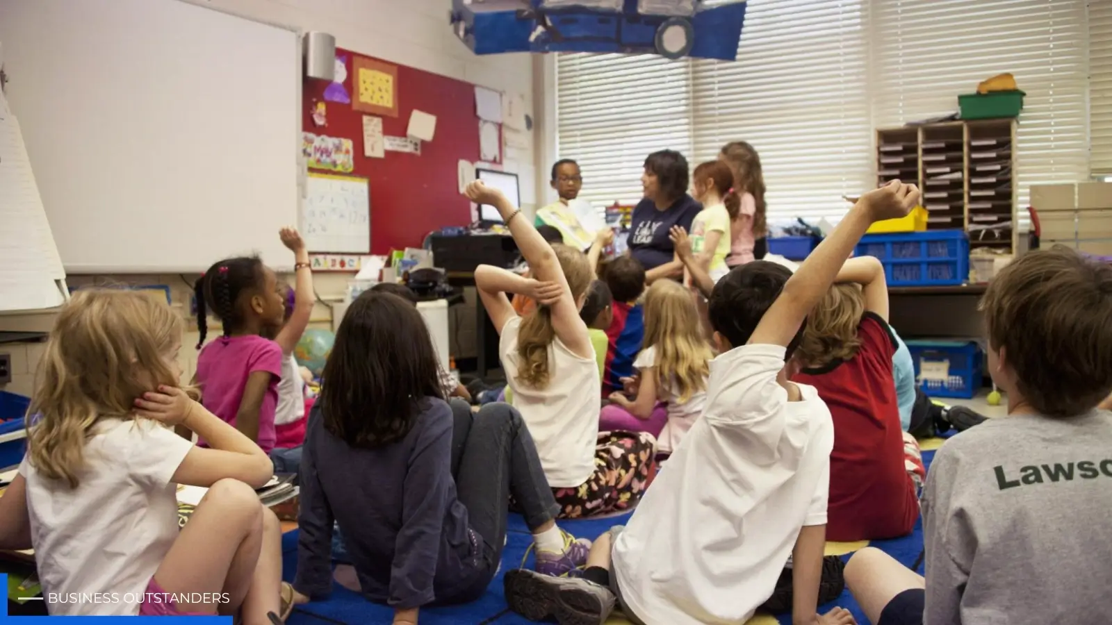 Expat children in school uniforms studying together in a modern Singapore international primary school classroom