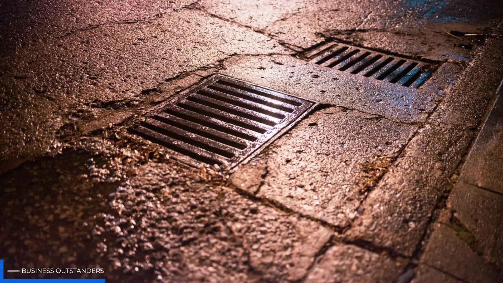 Homeowner inspecting standing water and drainage issues near home foundation after heavy rainfall