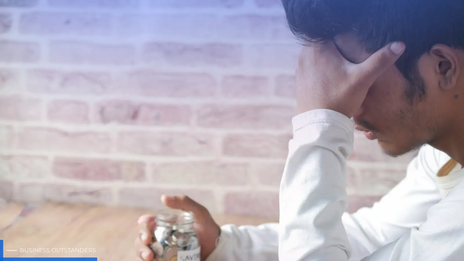 Person pausing to reflect before making a financial decision under emotional stress