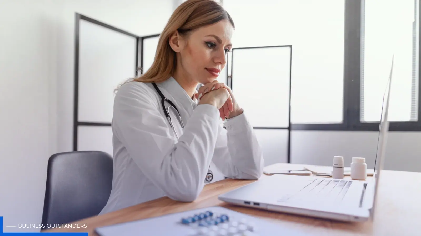 Professional adult reviewing ADHD medication and productivity strategies at a work desk