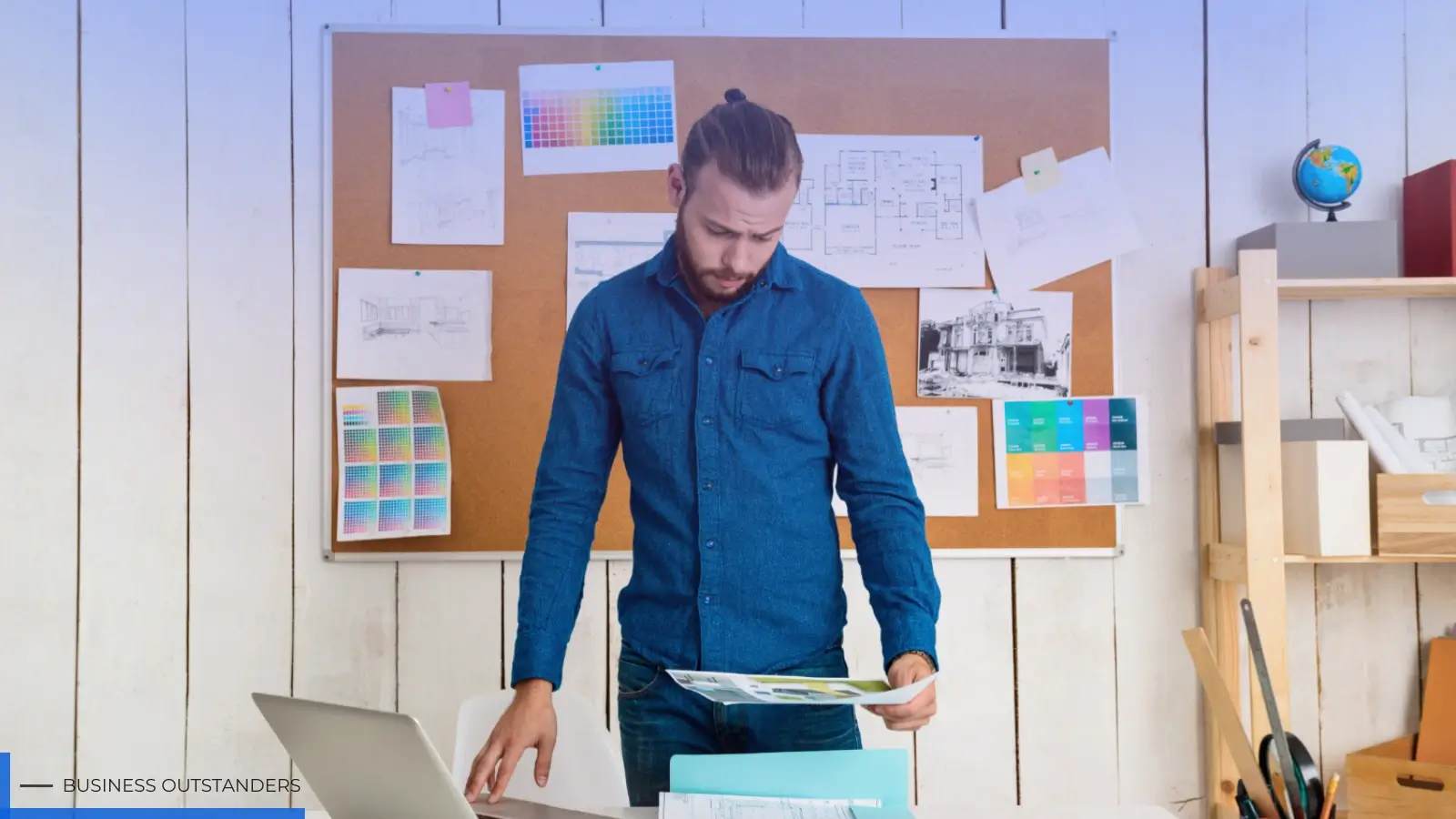 Startup founder working on brand identity strategy with logo and color palette on a desk