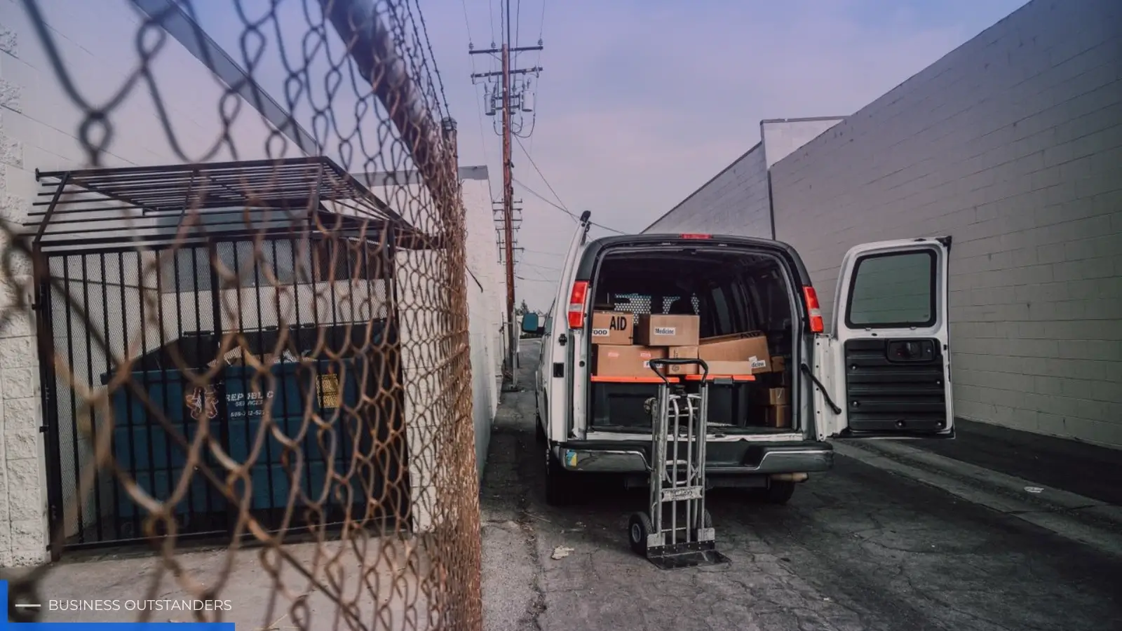 Technician inspecting a commercial loading dock door for repair issues at a warehouse facility