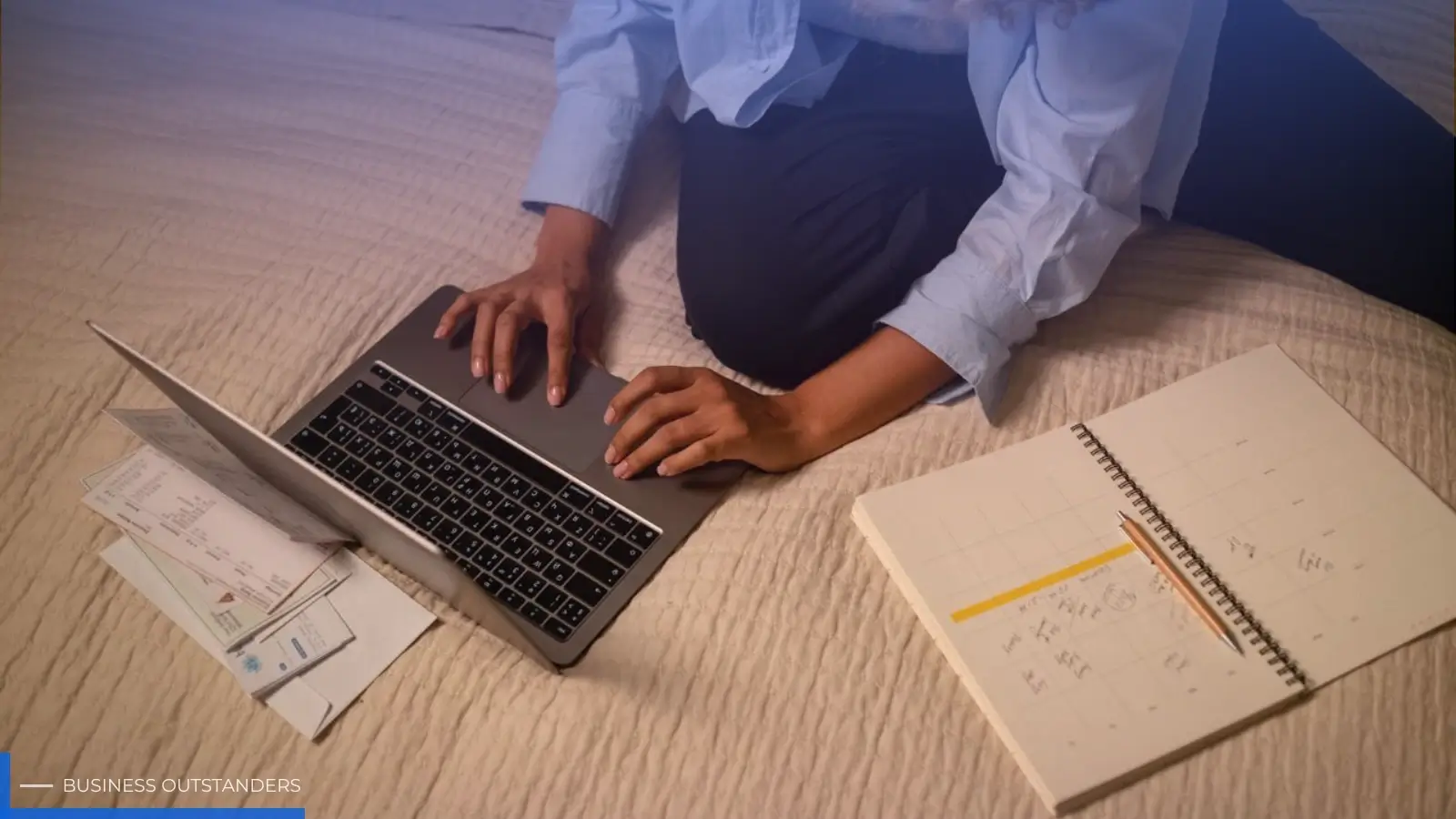Busy working parent organizing family schedule with a planner and digital calendar at home office desk