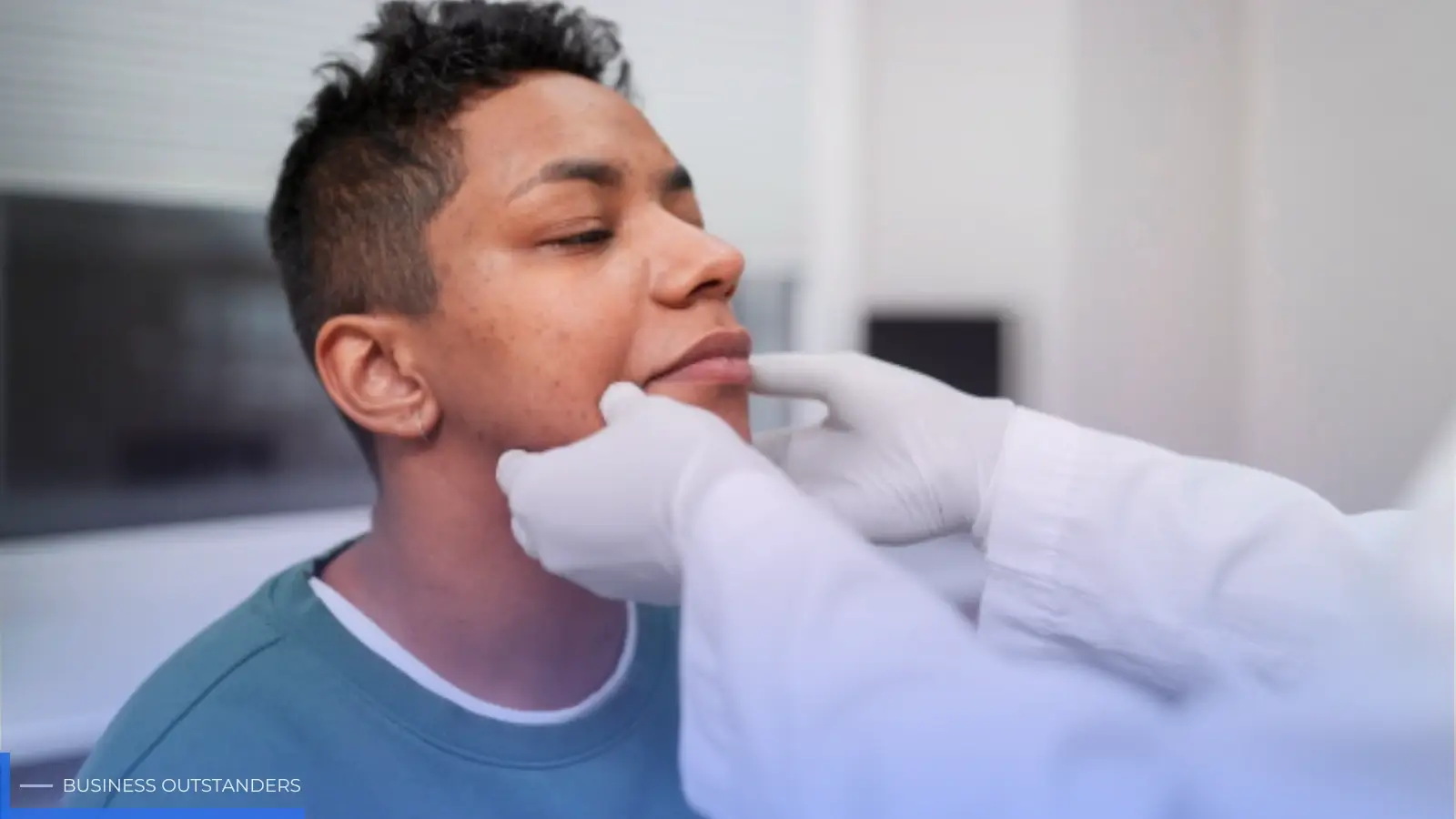 Person holding their jaw in pain due to a dental emergency requiring urgent care