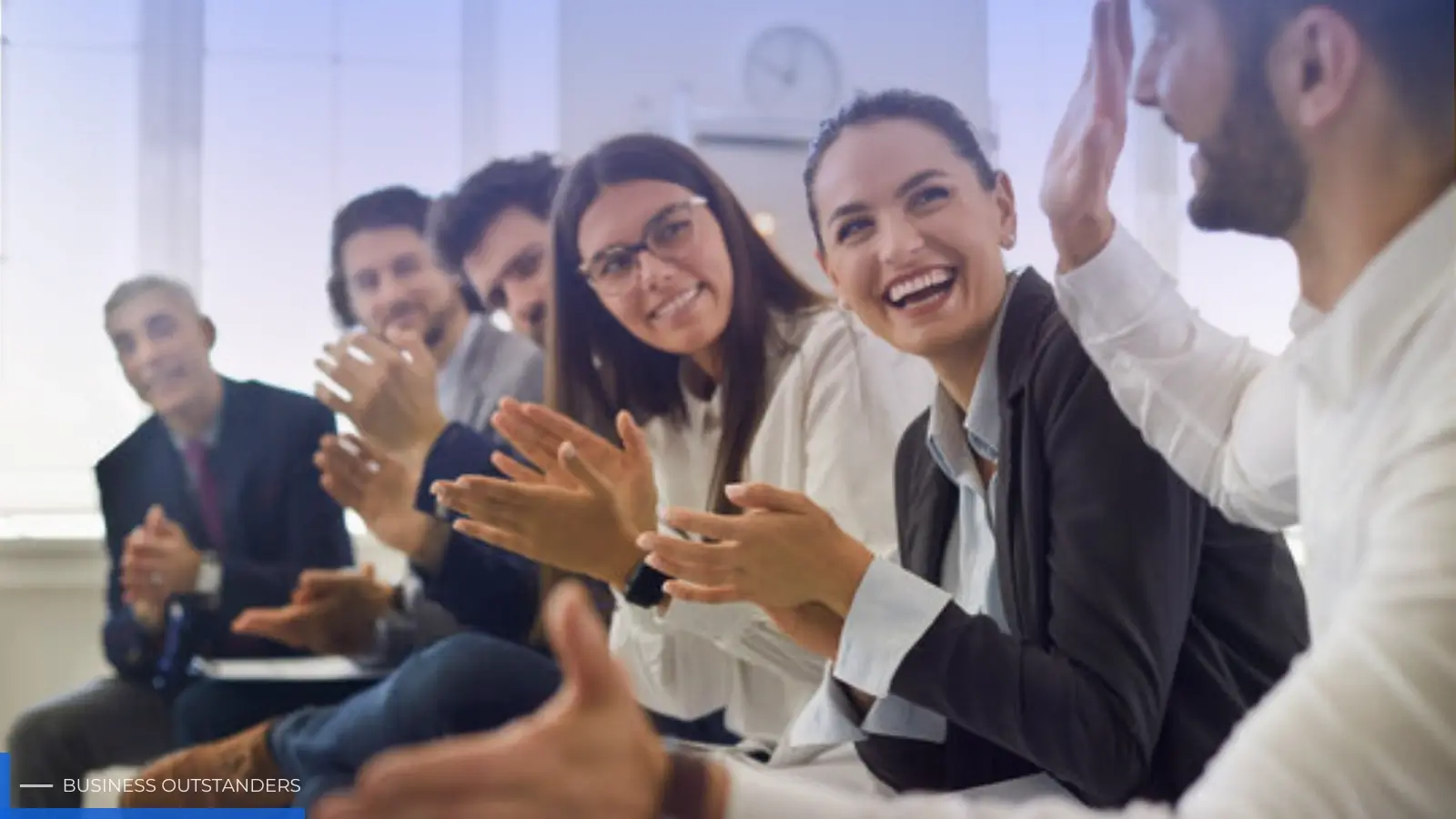Manager appreciating employee with a handshake in a modern corporate office setting
