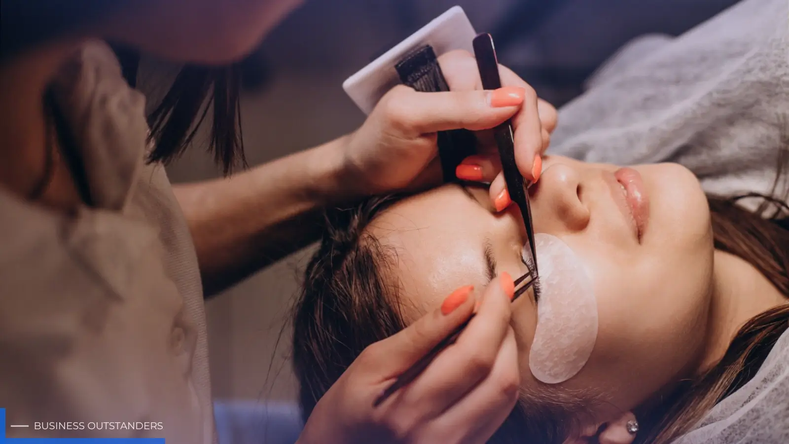 Professional lash technician applying semi-permanent eyelash extensions to a client in a modern beauty salon