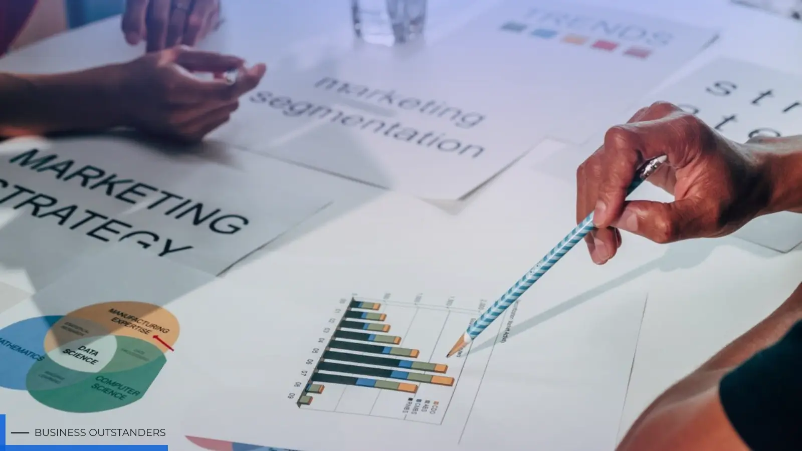 Small business owner reviewing niche market strategy and targeted customer segmentation chart