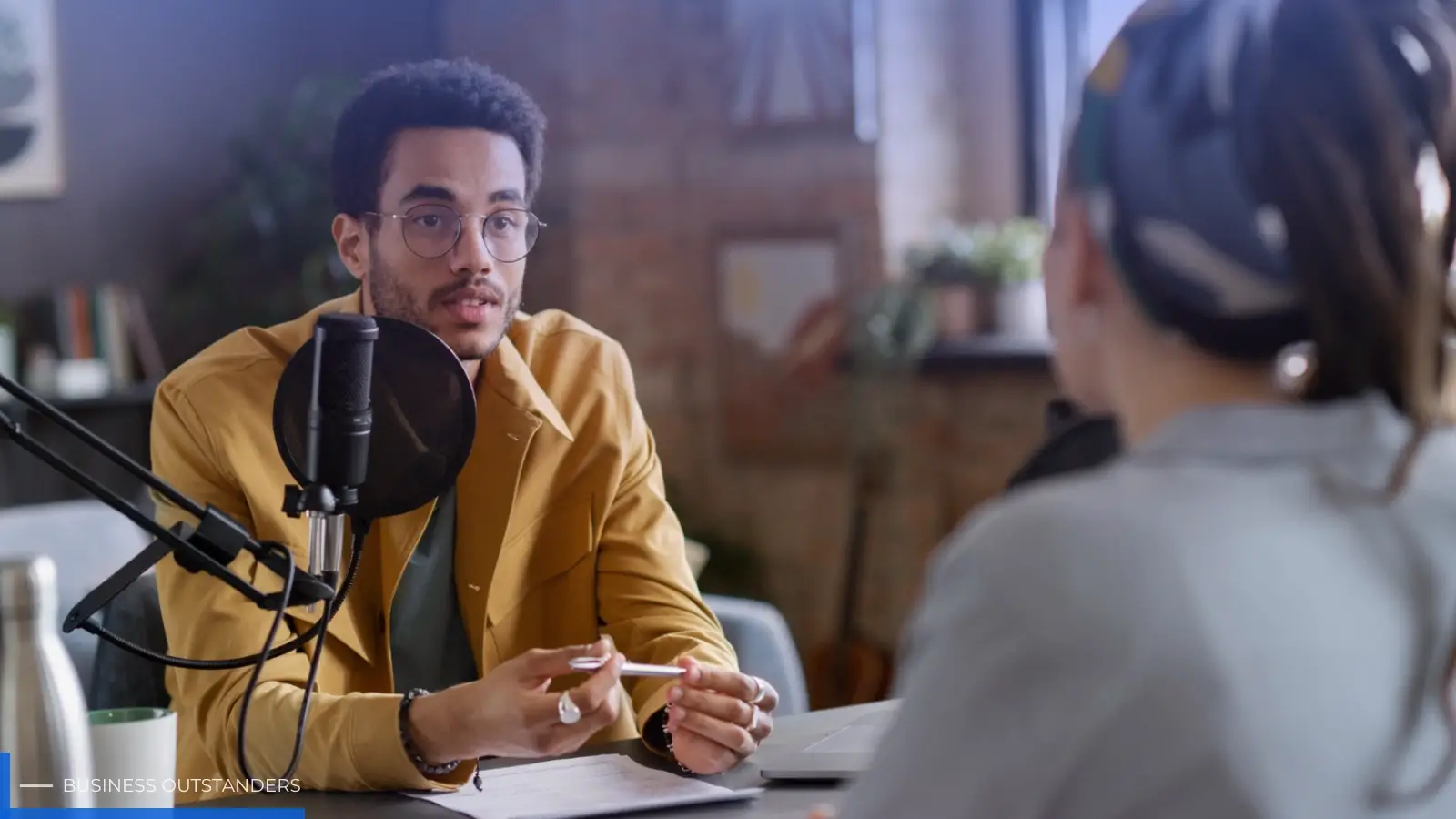 Business owner being interviewed on a podcast to build authority and reach new audiences