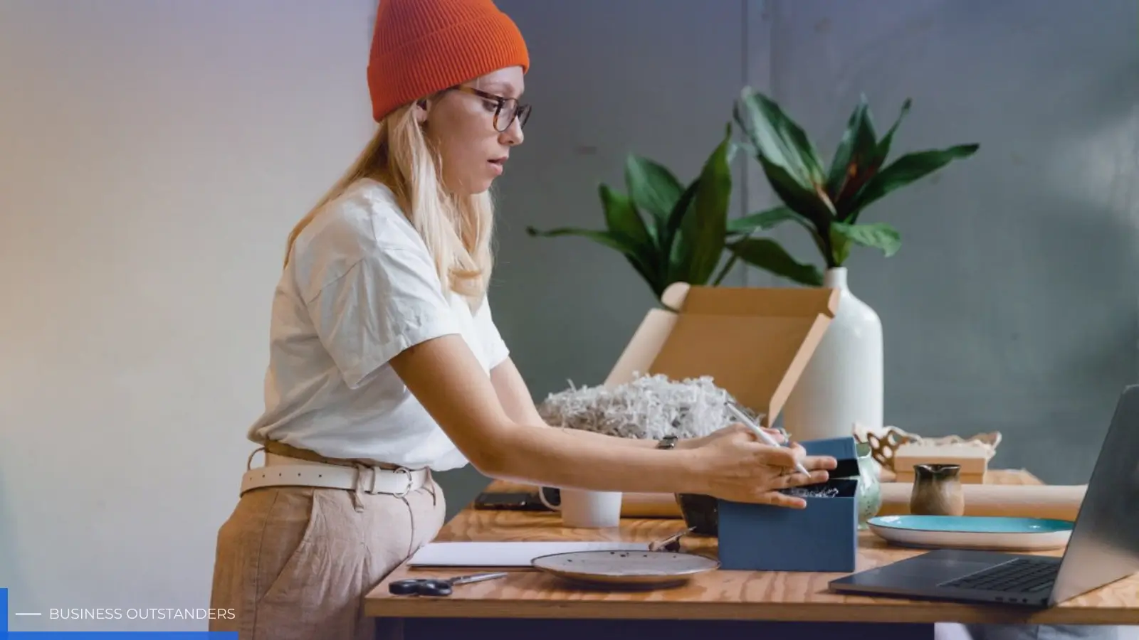 Small business owner reviewing premium promotional merchandise and branded swag items on a table
