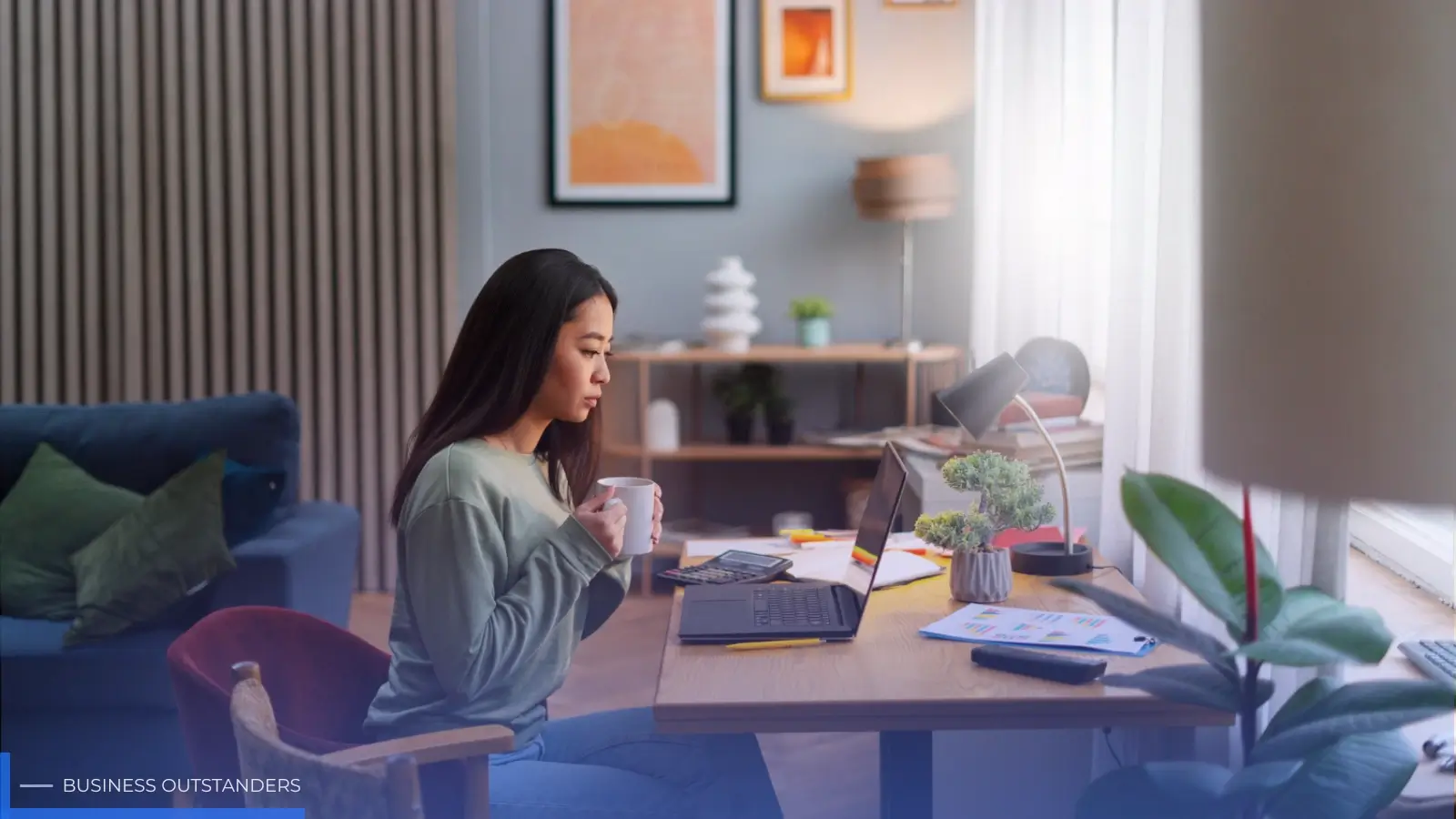 Person working from home at a stylish ergonomic desk setup in a cozy living room