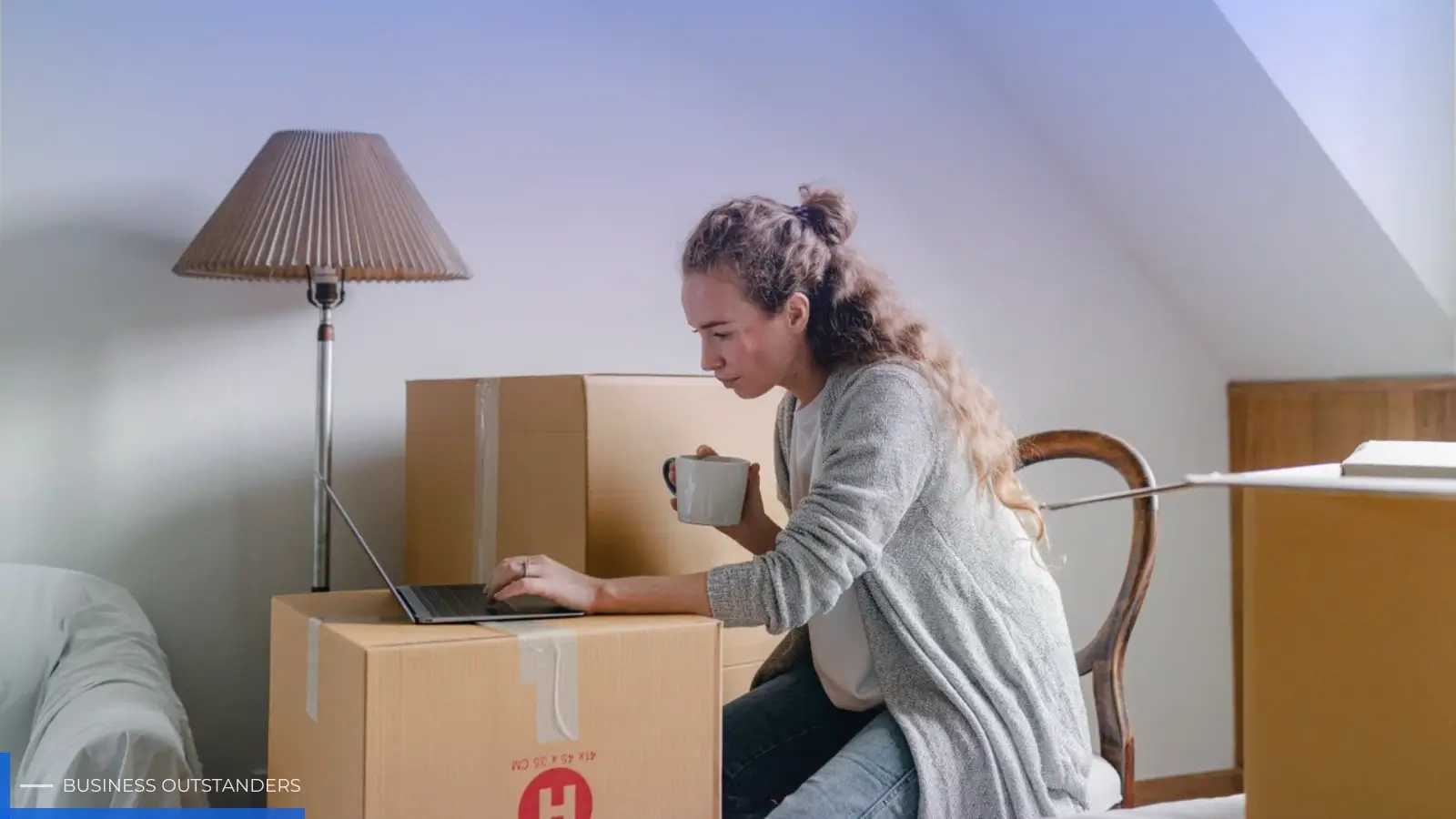 Person researching residential moving companies on a laptop before scheduling a home relocation